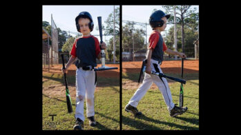 little boy in baseball uniform carrying a Tanner Tee and a bat